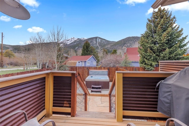 821 Pitkin St Unit 8, Frisco, CO 80443 - wooden terrace featuring a hot tub, a mountain view, and grilling area