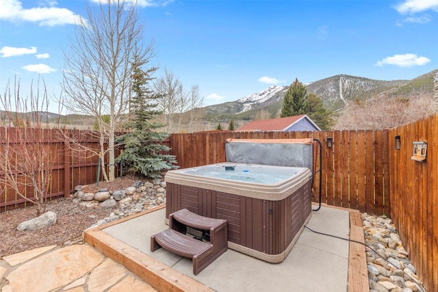 821 Pitkin St Unit 8, Frisco, CO 80443 - fenced backyard featuring a hot tub, a mountain view, and a patio area