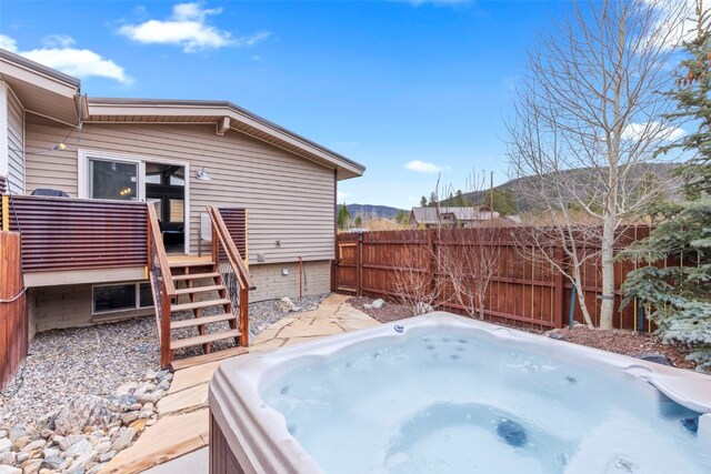 821 Pitkin St Unit 8, Frisco, CO 80443 - wooden deck with a hot tub, a fenced backyard, and stairway