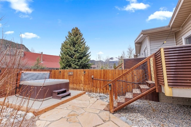 821 Pitkin St Unit 8, Frisco, CO 80443 - fenced backyard with a hot tub, a patio, stairway, and a mountain view