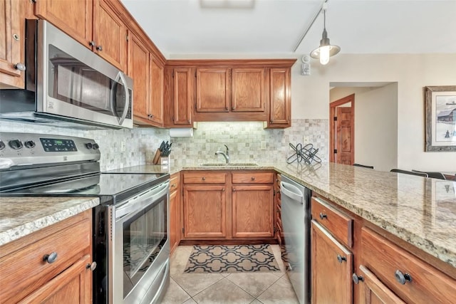 1995 Storm Meadows Dr Unit 307, Steamboat Springs, CO 80487 - kitchen featuring stainless steel appliances, brown cabinetry, and decorative backsplash