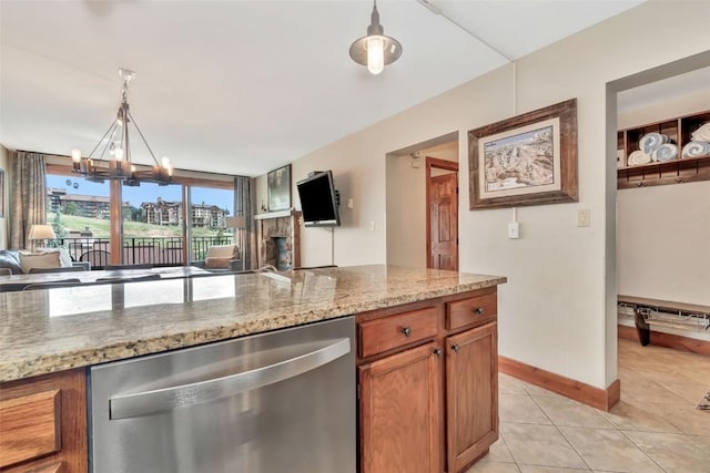 1995 Storm Meadows Dr Unit 307, Steamboat Springs, CO 80487 - kitchen with dishwasher, light tile patterned floors, brown cabinetry, hanging light fixtures, and light stone counters