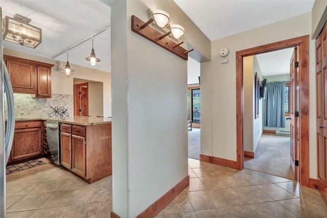 1995 Storm Meadows Dr Unit 307, Steamboat Springs, CO 80487 - kitchen featuring dishwasher, light tile patterned flooring, backsplash, and brown cabinetry
