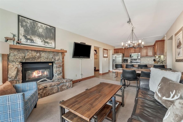 1995 Storm Meadows Dr Unit 307, Steamboat Springs, CO 80487 - living area featuring a chandelier, light colored carpet, and a stone fireplace