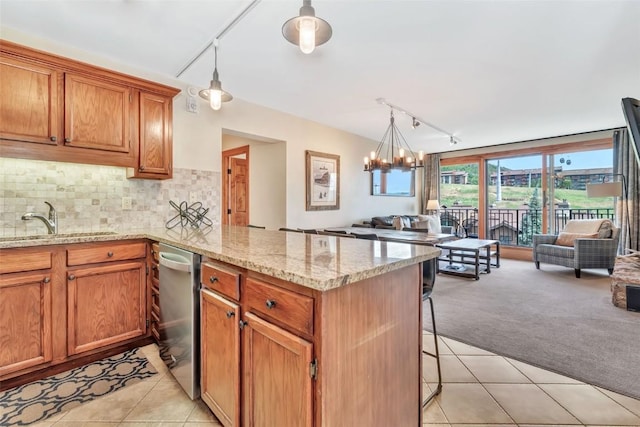 1995 Storm Meadows Dr Unit 307, Steamboat Springs, CO 80487 - kitchen with open floor plan, track lighting, a peninsula, and dishwasher