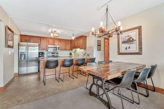 1995 Storm Meadows Dr Unit 307, Steamboat Springs, CO 80487 - dining room featuring a chandelier, light tile patterned floors, and light colored carpet