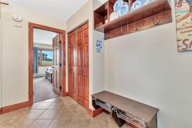 1995 Storm Meadows Dr Unit 307, Steamboat Springs, CO 80487 - mudroom featuring light carpet, a baseboard heating unit, and light tile patterned floors