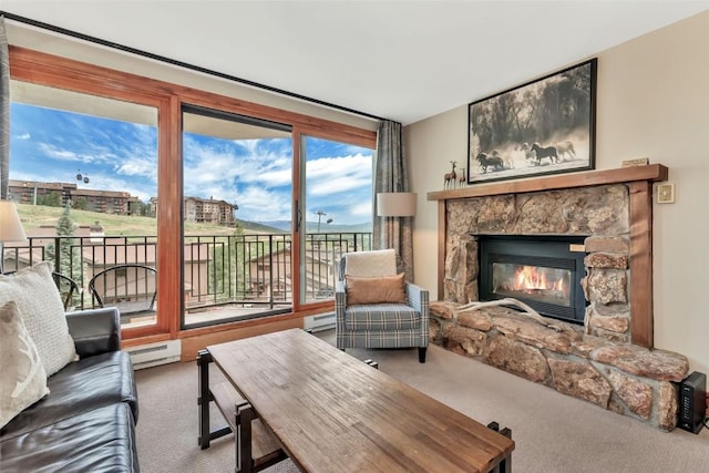 1995 Storm Meadows Dr Unit 307, Steamboat Springs, CO 80487 - carpeted living area featuring a baseboard heating unit and a fireplace