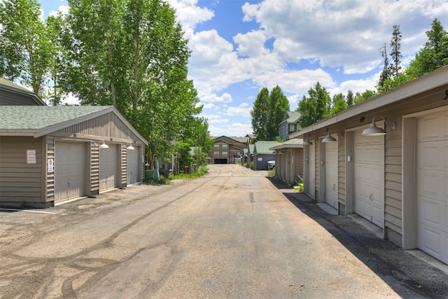 307 Saddle Ridge Dr Unit 307, Wildernest, CO 80498 - view of asphalt road with community garages and a residential view