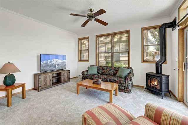 307 Saddle Ridge Dr Unit 307, Wildernest, CO 80498 - living area featuring a wood stove, light colored carpet, ceiling fan, ornamental molding, and a textured ceiling