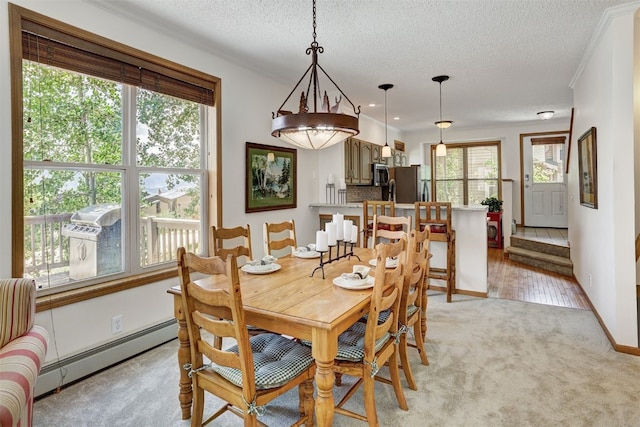 307 Saddle Ridge Dr Unit 307, Wildernest, CO 80498 - dining space with a baseboard heating unit, a textured ceiling, and light colored carpet