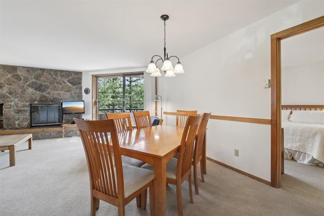 210 E Ln Bonte St Unit 121, Dillon, CO 80435 - dining room featuring light colored carpet, a chandelier, and a fireplace