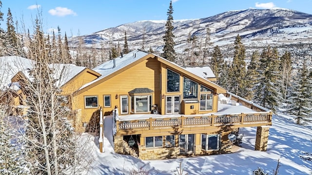 252 Lake View Dr, Silverthorne, CO 80498 - view of front of property with a deck with mountain view and stone siding