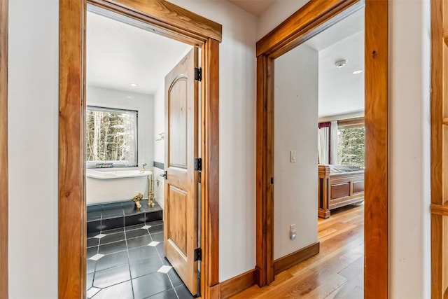 252 Lake View Dr, Silverthorne, CO 80498 - hallway featuring healthy amount of natural light, wood finished floors, baseboards, and recessed lighting