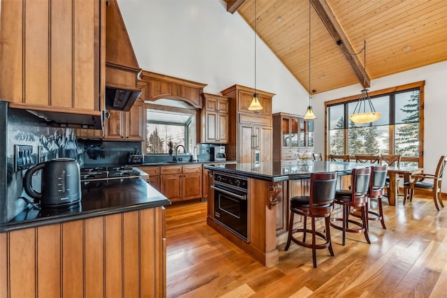 252 Lake View Dr, Silverthorne, CO 80498 - kitchen with oven, dark countertops, light wood-style floors, a sink, and high vaulted ceiling