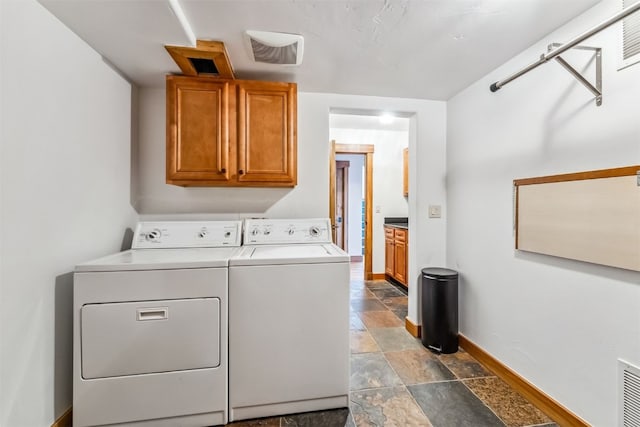 252 Lake View Dr, Silverthorne, CO 80498 - laundry room with cabinet space, separate washer and dryer, stone finish floors, and baseboards