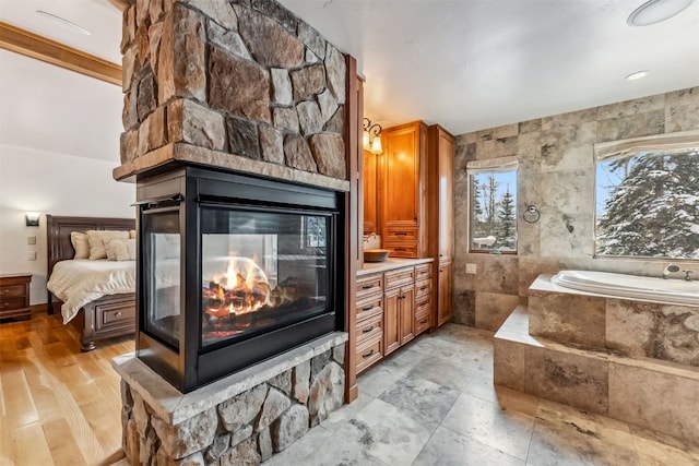 252 Lake View Dr, Silverthorne, CO 80498 - ensuite bathroom with a stone fireplace, a garden tub, and vanity