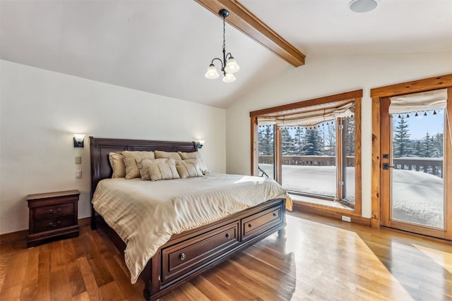 252 Lake View Dr, Silverthorne, CO 80498 - bedroom with access to exterior, wood finished floors, and a chandelier