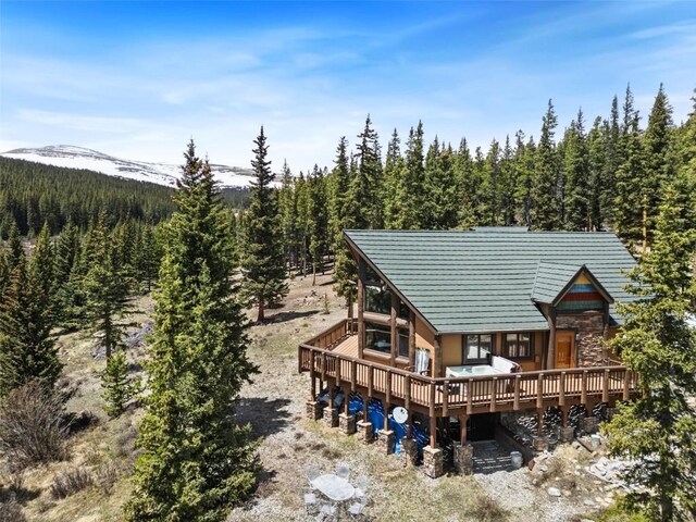 36 Silk Sisters Pl, Fairplay, CO 80440 - rear view of house featuring a wooded view, stone siding, and a wooden deck
