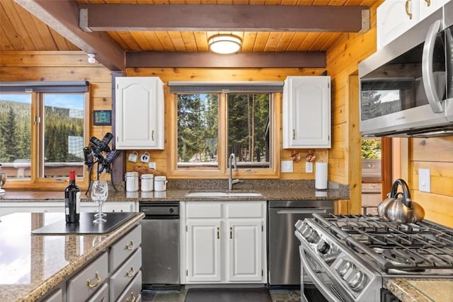 36 Silk Sisters Pl, Fairplay, CO 80440 - kitchen with stainless steel appliances, a sink, wood walls, wooden ceiling with exposed beams, and white cabinetry