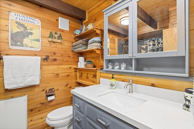 36 Silk Sisters Pl, Fairplay, CO 80440 - bathroom featuring wooden walls, toilet, vanity, wood ceiling with exposed beams, and curtained shower
