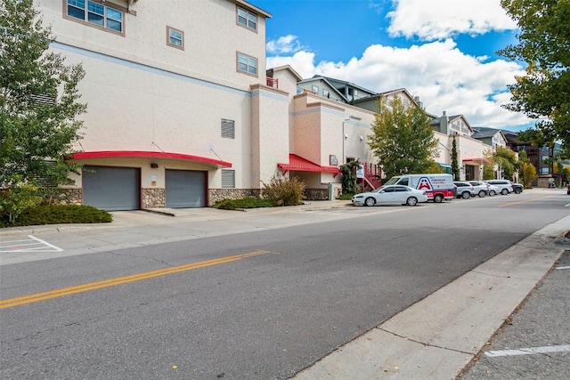view of road featuring a residential view, sidewalks, and curbs