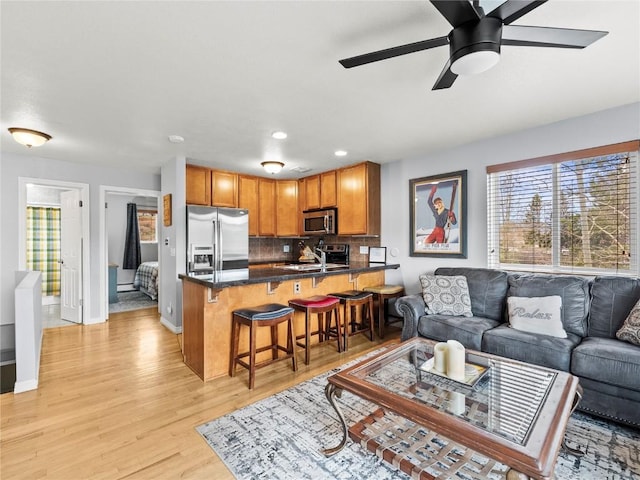 414 Tenderfoot St Unit 1, Dillon, CO 80435 - living room with light wood finished floors, ceiling fan, recessed lighting, and baseboards