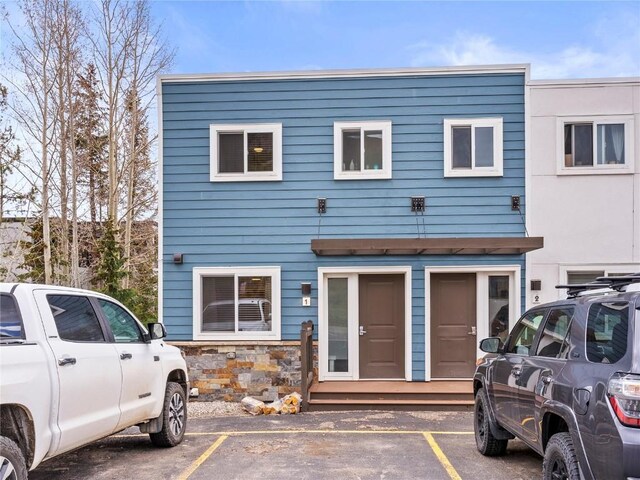 414 Tenderfoot St Unit 1, Dillon, CO 80435 - view of front of home with uncovered parking and stone siding