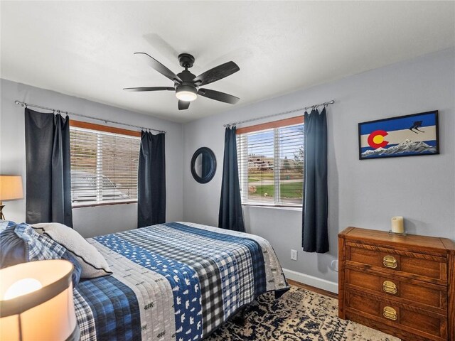 414 Tenderfoot St Unit 1, Dillon, CO 80435 - bedroom featuring wood finished floors, a ceiling fan, and baseboards