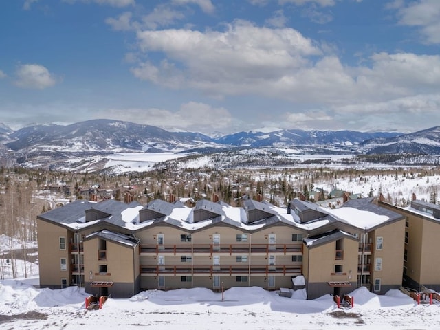 snowy aerial view with a mountain view