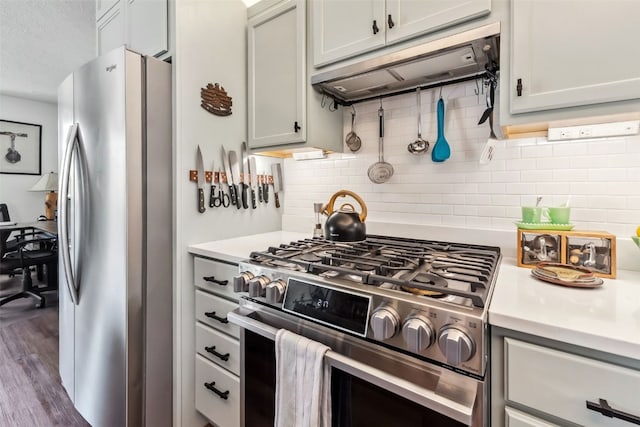 340 Straight Creek Dr Unit 206, Dillon, CO 80435 - kitchen with appliances with stainless steel finishes, under cabinet range hood, light countertops, and decorative backsplash
