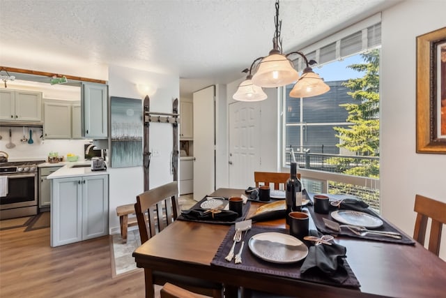 340 Straight Creek Dr Unit 206, Dillon, CO 80435 - dining area featuring a textured ceiling and light wood-style floors