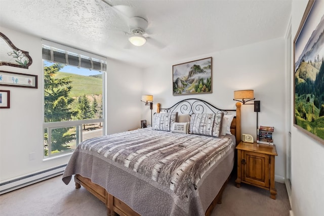 340 Straight Creek Dr Unit 206, Dillon, CO 80435 - carpeted bedroom with multiple windows, a baseboard radiator, and ceiling fan
