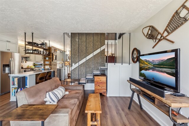 340 Straight Creek Dr Unit 206, Dillon, CO 80435 - living area with dark wood-style floors and a textured ceiling