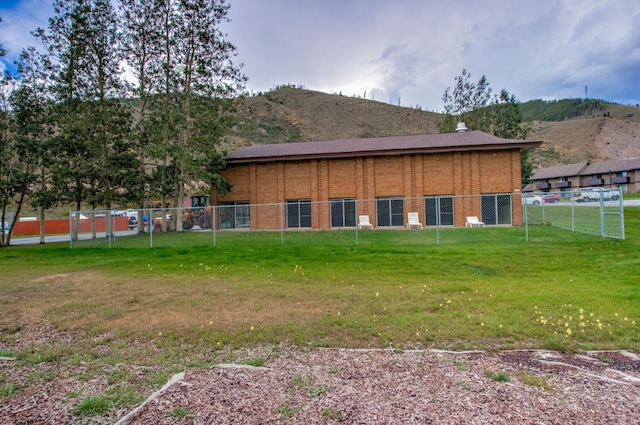 view of property exterior featuring a mountain view and a yard