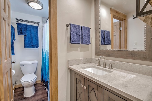 bathroom with vanity, wood-type flooring, and toilet