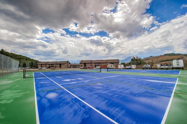 view of tennis court with a mountain view