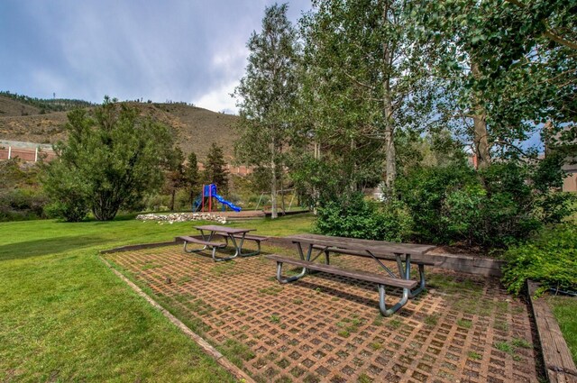 view of home's community featuring a mountain view and a yard