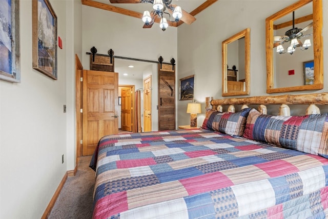 22714 US Highway 6 Unit 5977, Keystone, CO 80435 - bedroom with carpet floors, a barn door, baseboards, a high ceiling, and ceiling fan