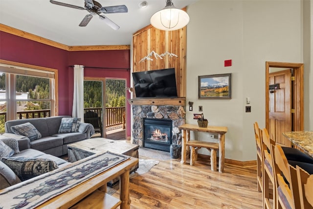 22714 US Highway 6 Unit 5977, Keystone, CO 80435 - living room featuring plenty of natural light, a ceiling fan, a stone fireplace, and light wood finished floors