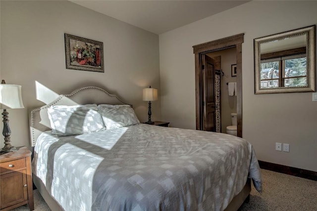 carpeted bedroom featuring connected bathroom