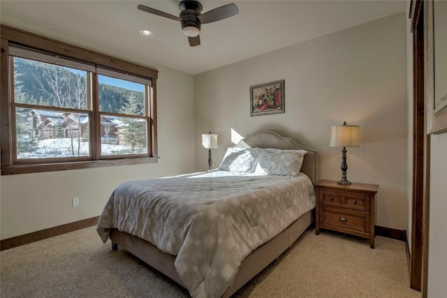 bedroom featuring light colored carpet and ceiling fan