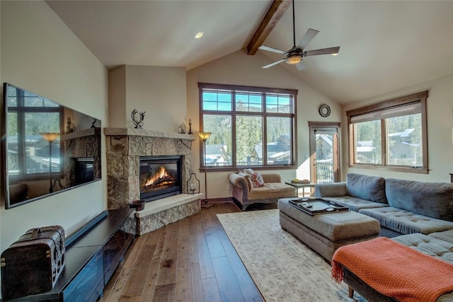 living room with high vaulted ceiling, hardwood / wood-style flooring, ceiling fan, a fireplace, and beamed ceiling