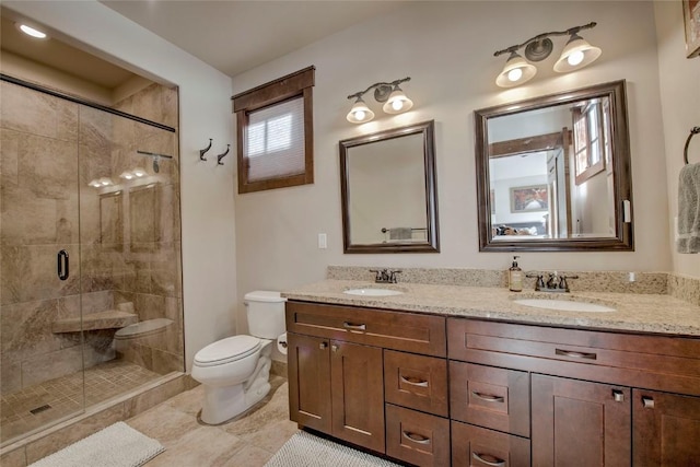 bathroom featuring tile patterned flooring, vanity, toilet, and walk in shower