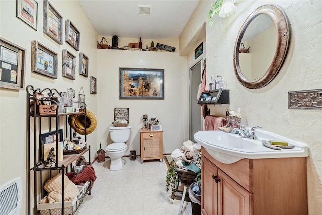 bathroom featuring toilet and vanity