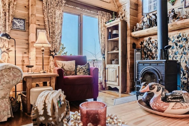 living area featuring wood finished floors and a wood stove