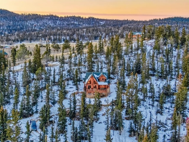 snowy aerial view with a forest view