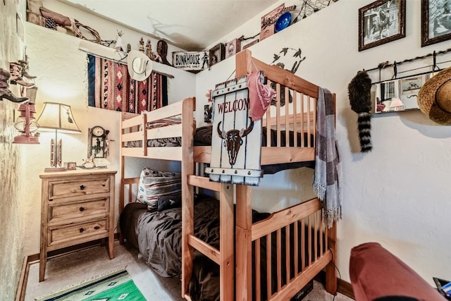 carpeted bedroom featuring baseboards