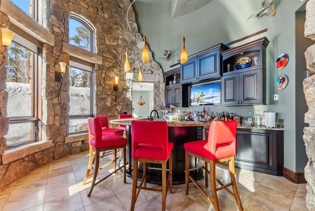 152 County Road 1040, Frisco, CO 80443 - bar with bar, a high ceiling, pendant lighting, and light tile patterned floors
