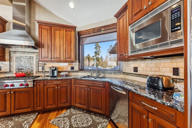152 County Road 1040, Frisco, CO 80443 - kitchen featuring lofted ceiling, stainless steel appliances, a sink, wall chimney exhaust hood, and decorative backsplash
